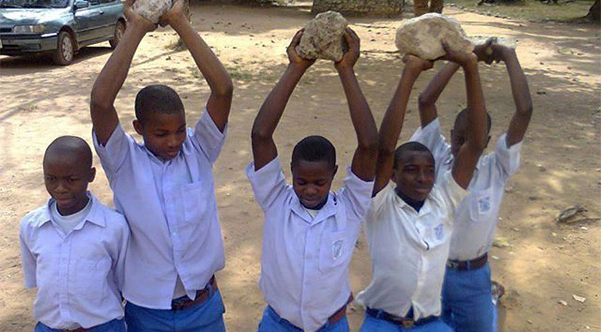 students carrying stones